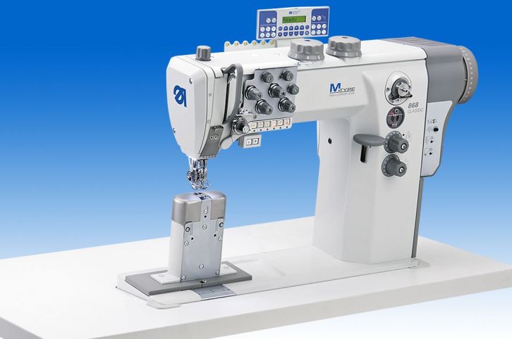 Twin needle lockstitch post bed machine with disconnectable needle bars and DA Direct Drive